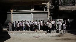 Aleppians_waiting_in_a_bread_line_during_the_Syrian_civil_war